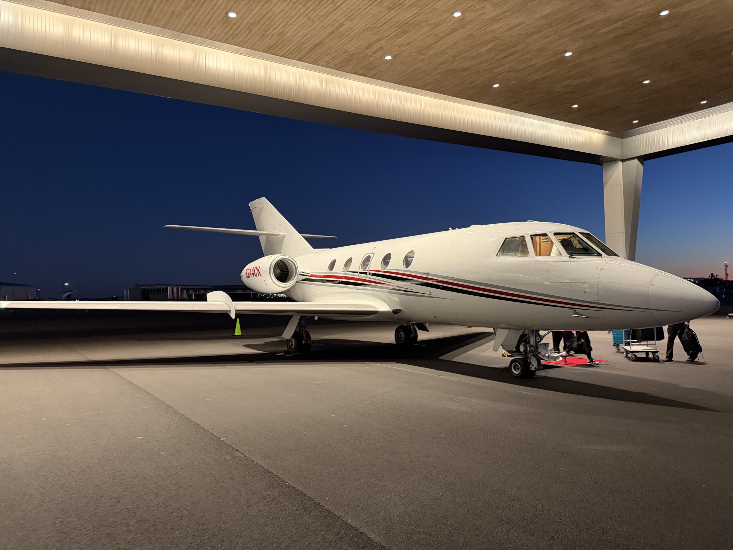 Dassault Falcon 20 business jet on the ramp at dusk